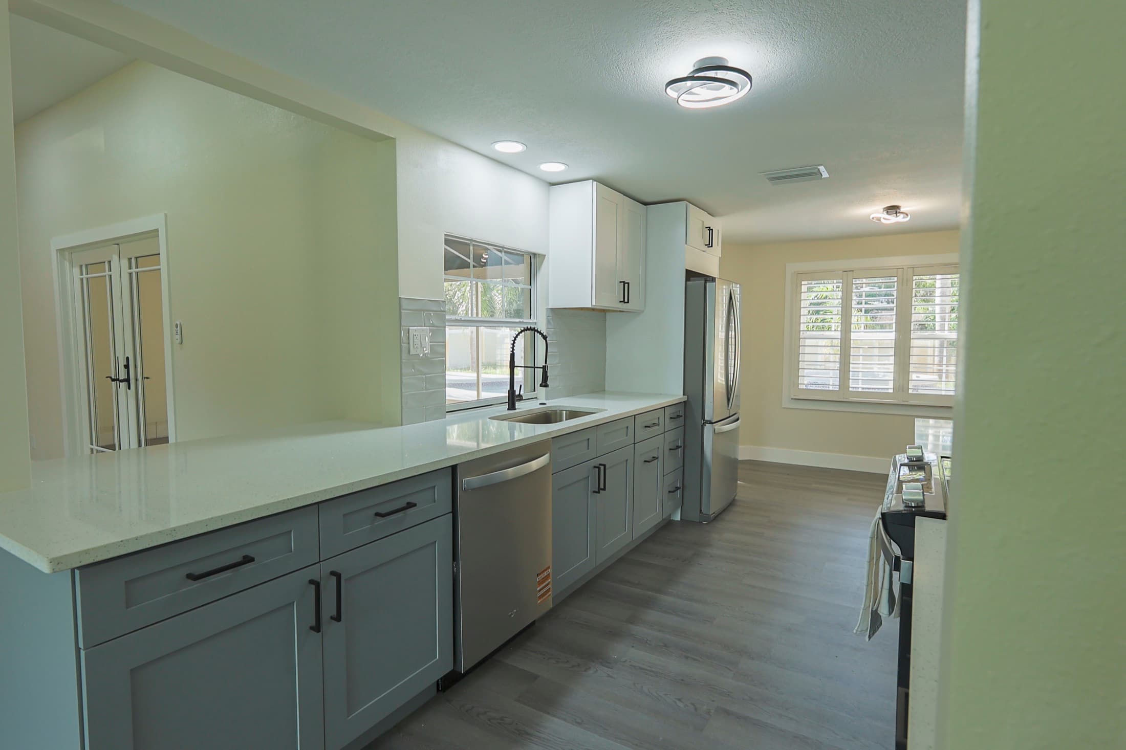 Kitchen with grey shaker cabinets and subway tile backsplash